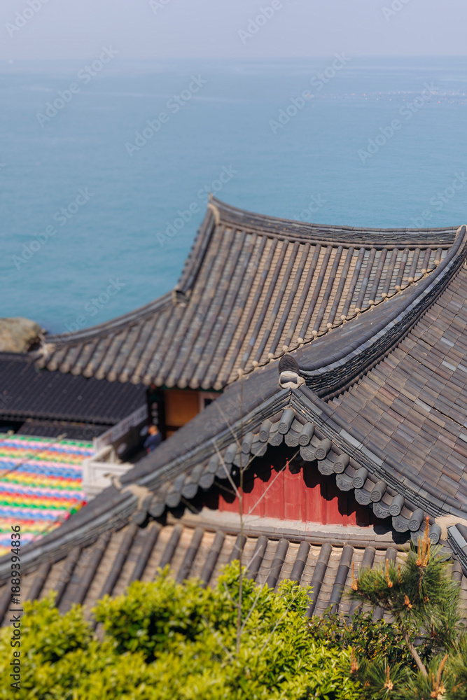 Fototapeta premium Busan, South Korea, Haedong Yonggungsa Temple view, Buddhist temple in Gijang-gun, coastal sea landscape with shrine facade exterior, Gijang County, Northern Busan, Yeongnam region, sunny spring day