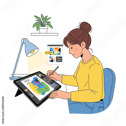 Woman drawing on digital tablet at desk, creative workspace