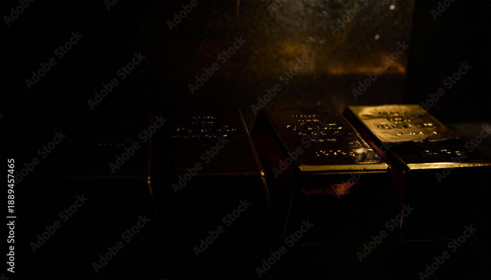 Obraz premium Dark conceptual photography of gold bars emerging from shadows inside a vault background