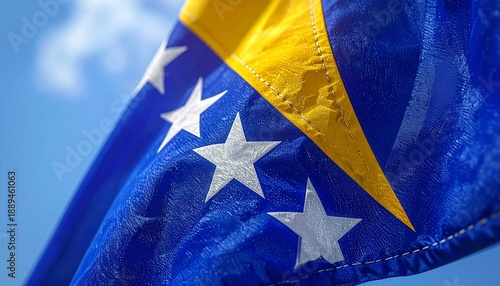Close-up Detail of Bosnia and Herzegovina Flag Waving in the Wind against Blue Sky
