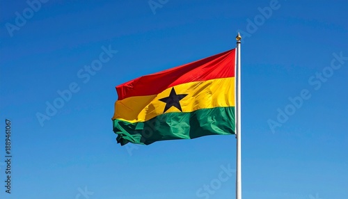 National Flag of Ghana Waving on Flagpole against Blue Sky