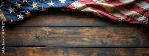Worn american flag draped across dark weathered wooden table evoking nostalgia and solemn patriotism