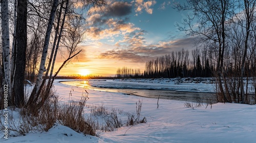 Wallpaper Mural Alaska winter sunset over river, snow covered ground, birch tree branches, icy stream, forest, cloudy sky, warm glow against cold white landscape for peaceful serene nature scene Torontodigital.ca