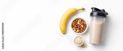 Banana, nuts, protein powder and smoothie shaker. Healthy nutrition and fitness concept. Protein shake preparation for sport, copy space, banner