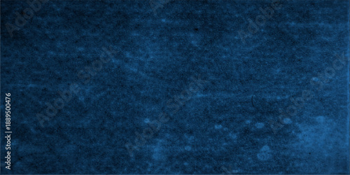 A vintage blue grunge background features a dark textured fabric pattern and rough denim material surface, creating an abstract textile wallpaper design with a weathered paper canvas backdrop