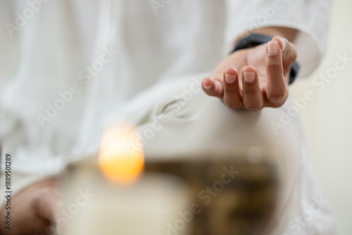 Schilderij op canvas Mindful woman sitting white outfit holding hand gesture for deep sound healing m
