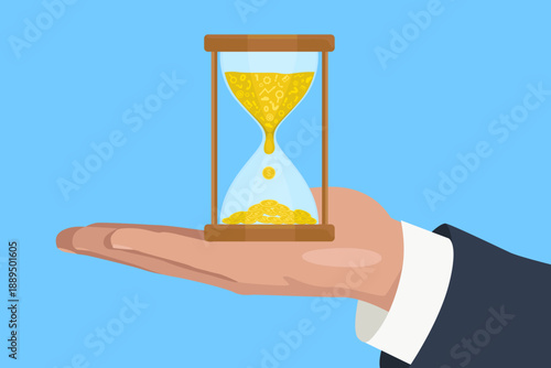 Hand holding hourglass. Hourglass with gold coins inside on blue background. Time and value concept