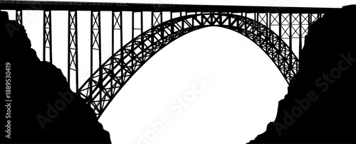 Massive steel arch bridge spanning a deep canyon silhouette