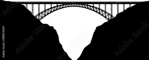 Large arch bridge silhouette spanning a deep mountain canyon