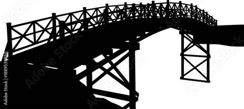 High wooden trestle bridge silhouette from a low angle