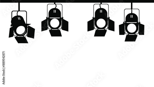 A row of stage lights hanging from a black metal bar