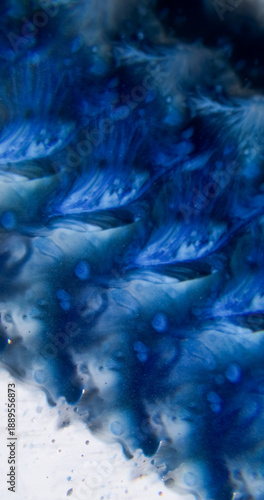 Defocused paint droplet. Pigment spread. Blue watercolor dye blotch on gray black acrylic. Abstract wavy color mix prism background.