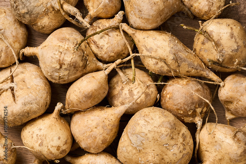 Photos flat lay pile of jicama or yam bean on wood table background