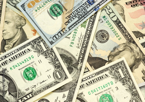 Obraz na plátně Close-up background of US dollar banknotes in different denominations