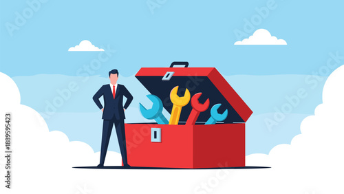 Professional businessman standing with hands on hips next to giant open red toolbox filled with colorful wrenches.