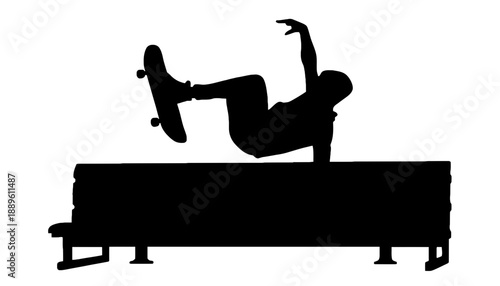 A silhouette of a skateboarder performing a trick on a bench