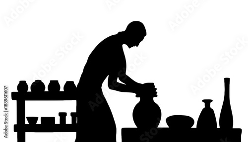 A black silhouette of a man working on a pottery wheel in a studio