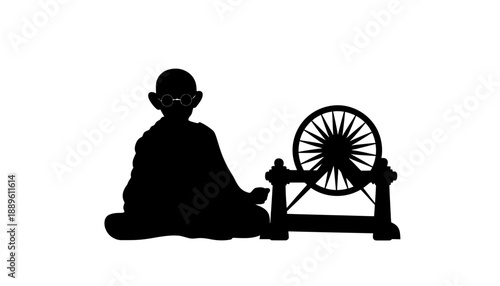 A black silhouette of Mahatma Gandhi sitting with a spinning wheel