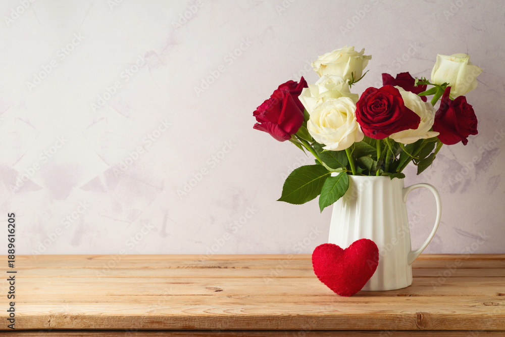 Fototapeta premium Happy Valentine's day concept with rose flowers and heart shape on wooden table over bright background