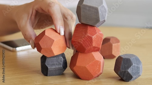 Cognitive development toy builds fine motor skills and logic through balance game Woman train focus and coordination using balance challenge creative stacking and mindful play Balance activity