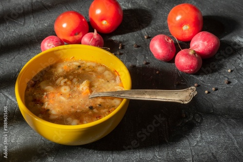 Dinner is food prepared for eating. Vegetables and a plate on a dark background