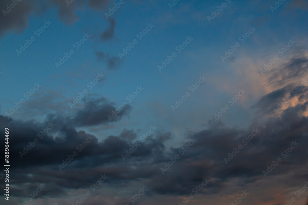 Obraz premium Calm Dusk Sky With Clouds At Twilight, Soft Blue Glow And Orange Hues