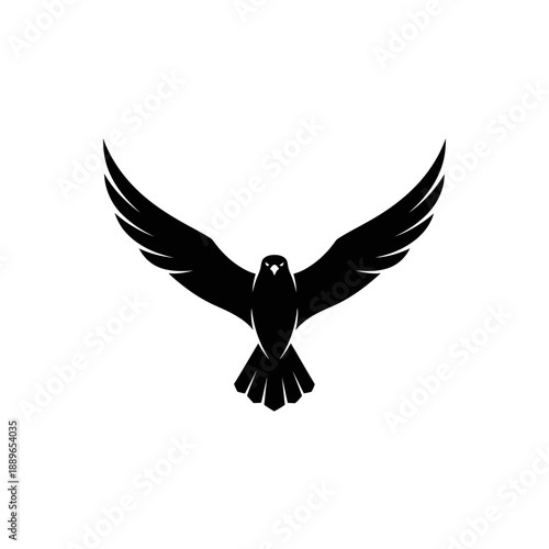 Silhouette of a black eagle with spread wings flying against a white background