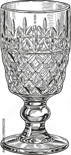 Elegant vintage crystal glass with intricate decorative cuts on a stemmed base