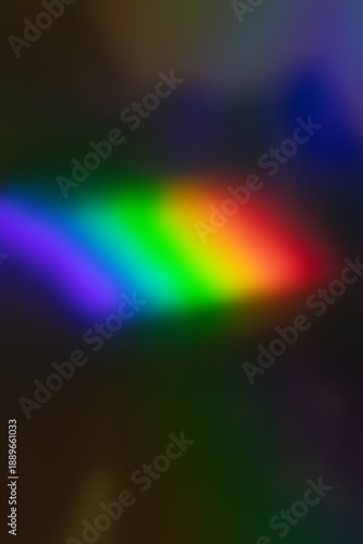 Abstract rainbow light on dark background with vibrant color gradient and blur