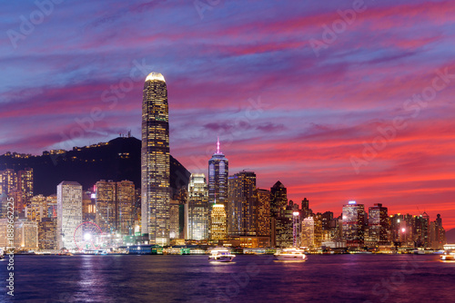 Photography Hong Kong city skyline at sunset with glowing sky and skyscrapers