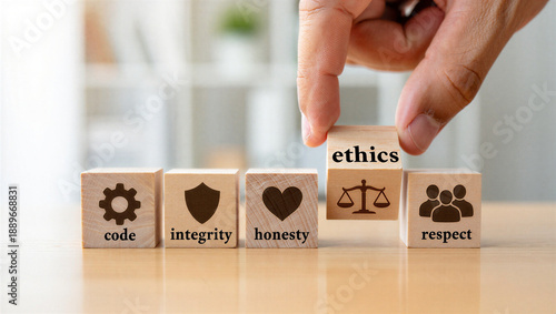hand placing ethics block on wooden cubes with code integrity honesty and respect