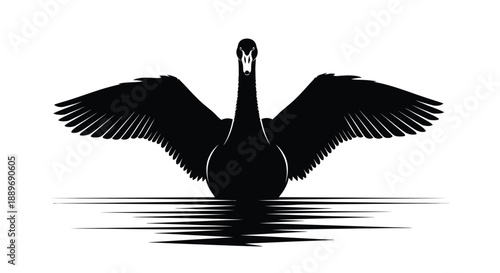 Silhouette of a swan with wings spread on calm water surface