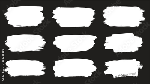 Collection of nine white paint brushstroke textures on a black background for artistic and distressed design effects.