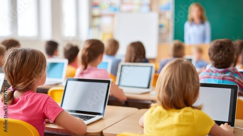 Students Using Laptops in Classroom with Teacher in Background Education Technology Concept
