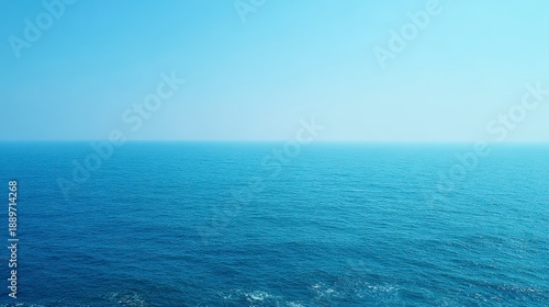 Tranquil Blue Ocean Horizon Under Clear Skies Reflecting Soft Sunlight in a Serene Landscape
