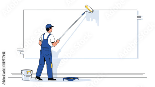 Professional painter in blue overalls and a cap uses a long roller to apply white paint to a large wall in an interior space.