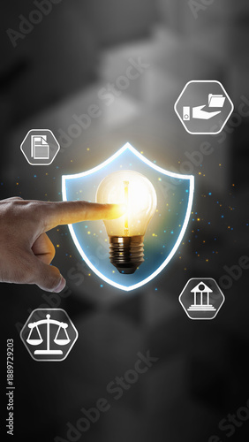 Εκτύπωση καμβά Hand touching a glowing lightbulb inside a shield, surrounded by legal icons