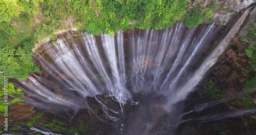 Top-Down Aerial View of Tumpak Sewu Waterfall Surrounded by Lush Tropical Forest, Indonesia