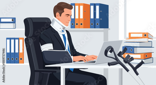 A man in a suit sits at a desk in an office, working on a laptop with a crutch nearby, surrounded by binders and papers.