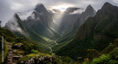 Dramatic mountain valley view reveals lush green slopes and a winding river below heavy mist
