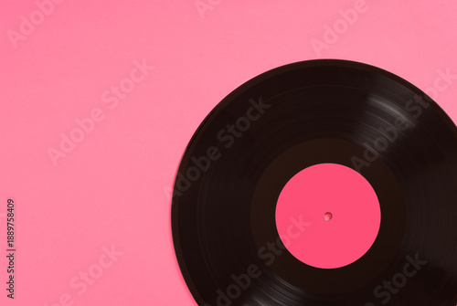Black vinyl record with pink label on pink background