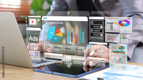 Business analytics and AI marketing dashboard displayed on digital tablet and laptop. Data visualization, advertising performance, automation, and business intelligence concept.