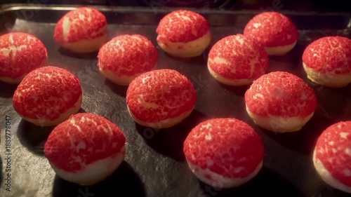 Choux pastry with craqueline. Profiteroles baking in oven. Timelapse of profiterole production. French dessert. Homemade food growth in oven. Bakery concept. Brewing cake. Red top. Close-up in 4K, UHD