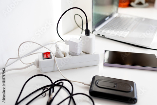 Bilde på lerret Plug in power outlet Adapter cord charger of smart phone on table