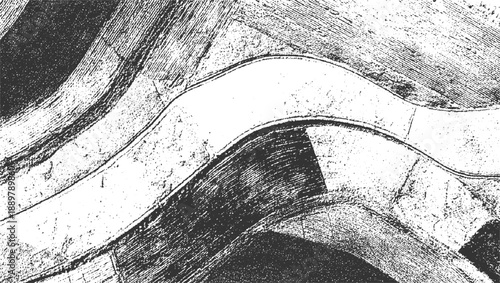 Black and white aerial view of a winding river and agricultural fields with textured patterns