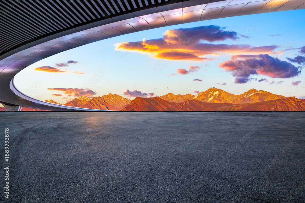 Fototapeta premium Empty asphalt road ground and modern bridge with beautiful mountain landscape at sunset