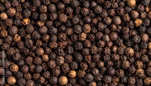 Dried black peppercorns spice texture background top view