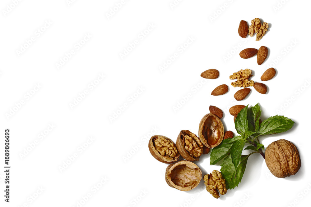Obraz premium Mixed Nuts with Basil Leaf on White Background