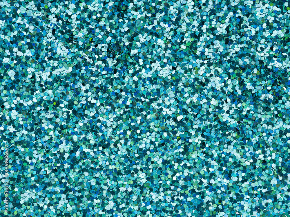 Fototapeta premium Blue glitter texture closeup. Saturated shiny holographic background for Christmas desktop, holiday New Year, xmas seasonal decoration, social events, greeting and wedding invitation card element.