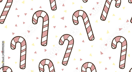 Colorful candy canes scattered on a festive background with small hearts and confetti from a top-down view